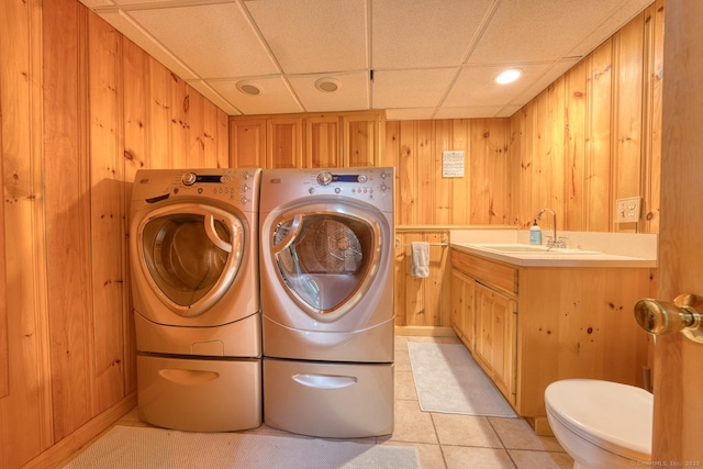 169 Dunn Rd, Coventry, CT 06238 - laundry area featuring separate washer and dryer, wood walls, and light tile patterned floors