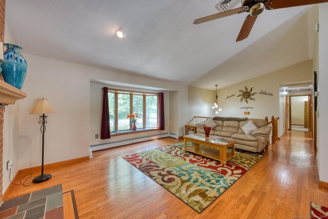 169 Dunn Rd, Coventry, CT 06238 - living area with a baseboard heating unit, a ceiling fan, wood finished floors, vaulted ceiling, and a textured ceiling