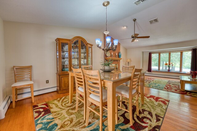 169 Dunn Rd, Coventry, CT 06238 - dining area featuring light wood-type flooring, vaulted ceiling, a ceiling fan, a chandelier, and baseboard heating