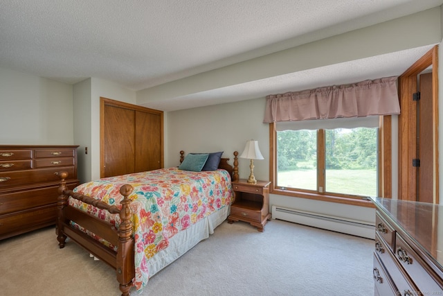 169 Dunn Rd, Coventry, CT 06238 - bedroom featuring a baseboard heating unit, light colored carpet, a closet, and a textured ceiling