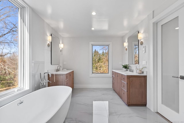 261 N St, Ridgefield, CT 06877 - bathroom with a freestanding bath, vanity, baseboards, recessed lighting, and marble finish floors