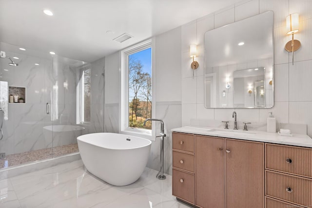 261 N St, Ridgefield, CT 06877 - full bath featuring tile walls, a marble finish shower, a freestanding bath, vanity, and marble tiled flooring