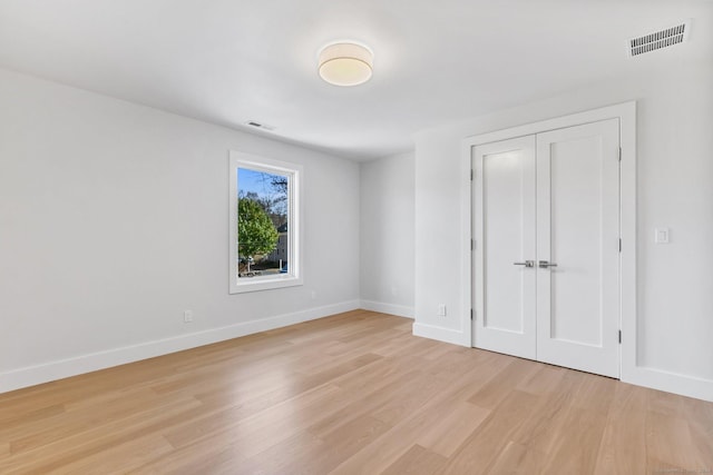 261 N St, Ridgefield, CT 06877 - unfurnished bedroom featuring light wood finished floors, baseboards, and a closet