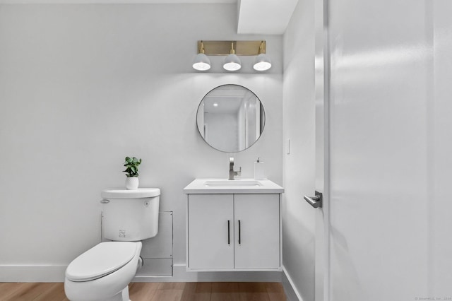 261 N St, Ridgefield, CT 06877 - bathroom with wood finished floors, toilet, baseboards, and vanity