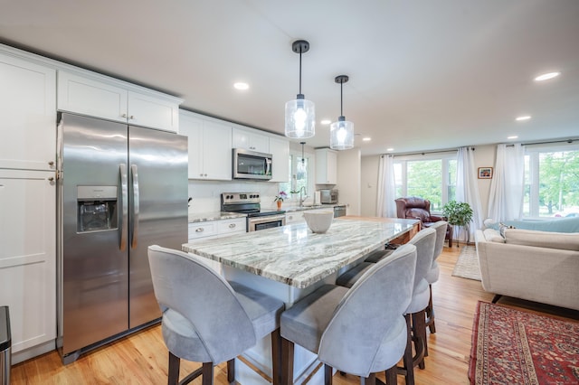 211 Brainard Rd, Enfield, CT 06082 - kitchen featuring appliances with stainless steel finishes, open floor plan, white cabinetry, light wood-style floors, and recessed lighting