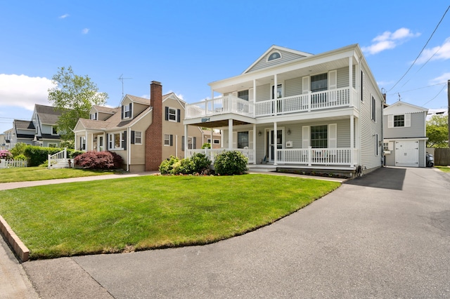 26 Parkway S, New London, CT 06320 - view of front of property featuring covered porch, a balcony, a front lawn, and driveway
