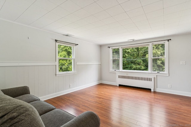 4 Buttonball Dr, Newtown, CT 06482 - living area with radiator heating unit, wood finished floors, and a wainscoted wall