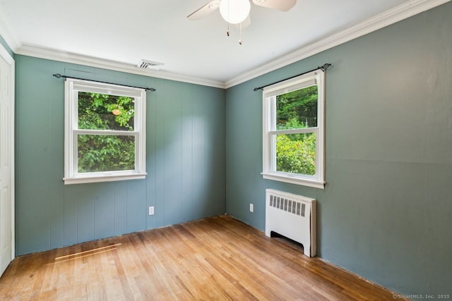 4 Buttonball Dr, Newtown, CT 06482 - unfurnished room featuring radiator heating unit, plenty of natural light, wood finished floors, ceiling fan, and crown molding