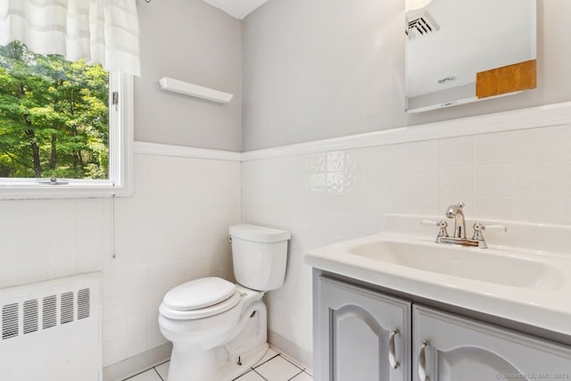 4 Buttonball Dr, Newtown, CT 06482 - bathroom with radiator heating unit, tile walls, vanity, tile patterned floors, and wainscoting