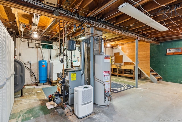 4 Buttonball Dr, Newtown, CT 06482 - unfinished basement featuring gas water heater, washer / clothes dryer, a water pressure tank, and a heating unit