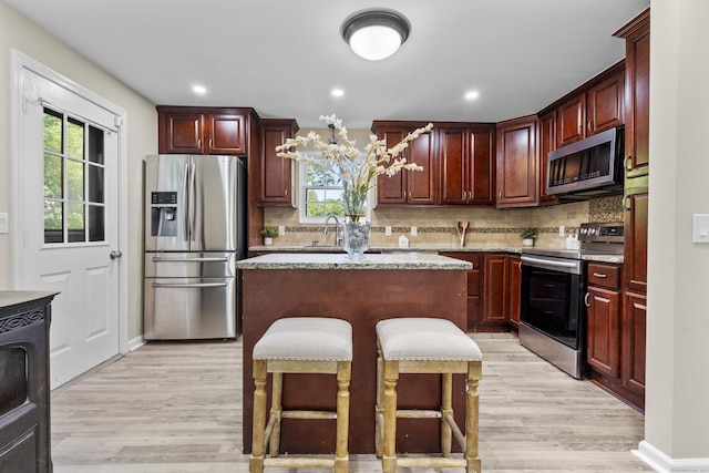 13 Williams Ct, Wolcott, CT 06716 - kitchen with appliances with stainless steel finishes, light wood-style floors, a sink, healthy amount of natural light, and recessed lighting