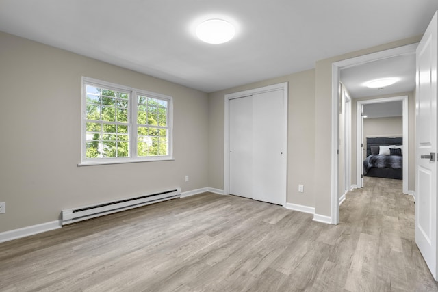13 Williams Ct, Wolcott, CT 06716 - unfurnished bedroom featuring a baseboard heating unit, light wood-style floors, a closet, and baseboards