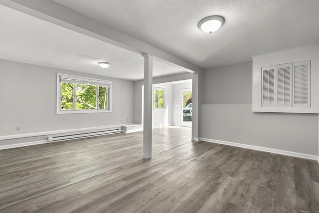 13 Williams Ct, Wolcott, CT 06716 - unfurnished room featuring a baseboard radiator, plenty of natural light, wood finished floors, a textured ceiling, and baseboards