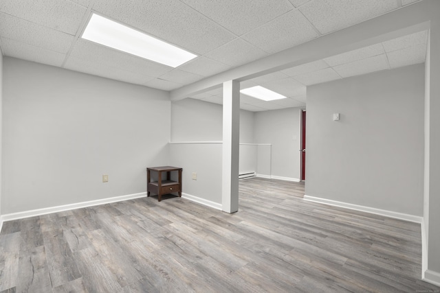 13 Williams Ct, Wolcott, CT 06716 - finished basement with a drop ceiling, wood finished floors, baseboards, and a baseboard heating unit