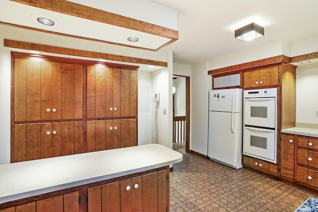 30 Bartling Dr, Easton, CT 06612 - kitchen with white appliances, brown cabinetry, light countertops, and tile patterned floors