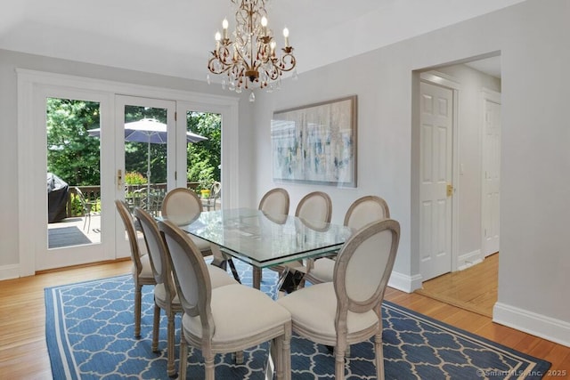 132 Old N Stamford Rd, Stamford, CT 06905 - dining area with baseboards, wood finished floors, and a chandelier