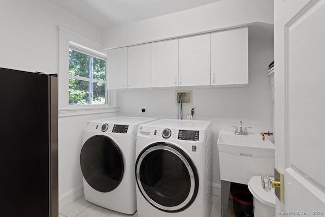 132 Old N Stamford Rd, Stamford, CT 06905 - laundry area featuring washing machine and dryer, cabinet space, baseboards, and light tile patterned flooring