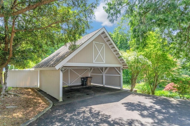 132 Old N Stamford Rd, Stamford, CT 06905 - garage featuring asphalt driveway and a detached carport