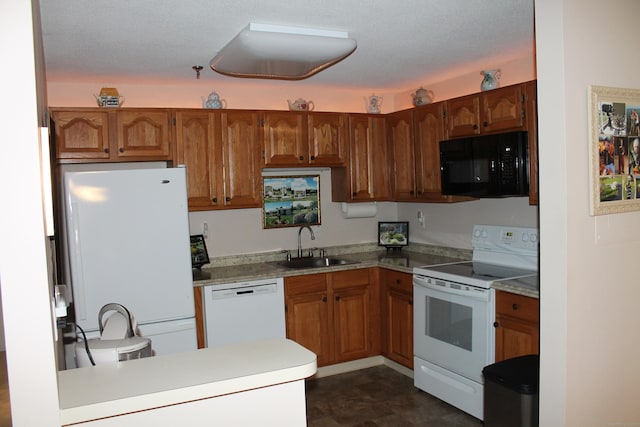 106 S Putter Dr Unit 106, Wallingford, CT 06492 - kitchen with white appliances, a sink, a peninsula, and brown cabinetry