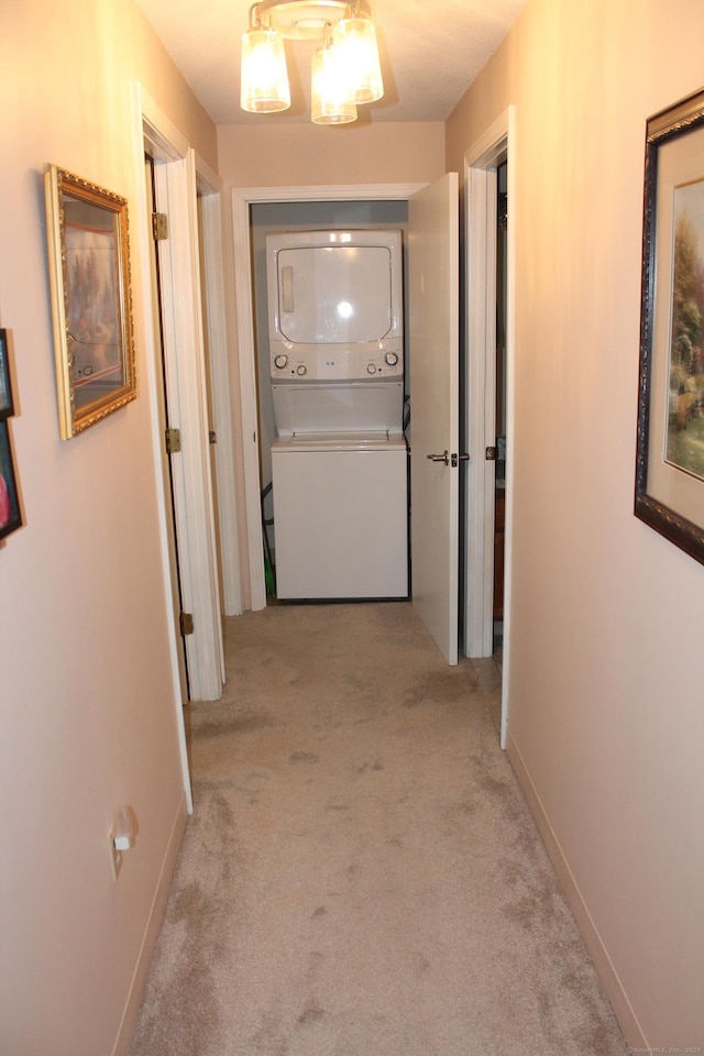 106 S Putter Dr Unit 106, Wallingford, CT 06492 - corridor featuring estacked washer and dryer, light carpet, and baseboards