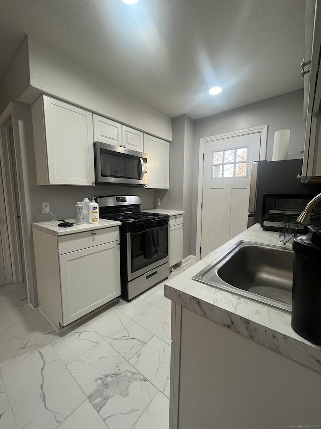 19 Fairmont Ave, New Haven, CT 06513 - kitchen with appliances with stainless steel finishes, light marble finish floors, white cabinetry, and recessed lighting