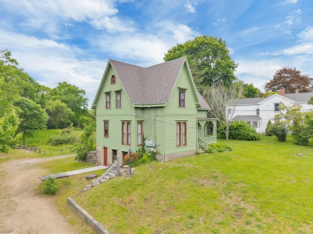 187 Whitehall Ave, Stonington, CT 06355 - view of property exterior featuring a yard, an attached garage, roof with shingles, driveway, and board and batten siding
