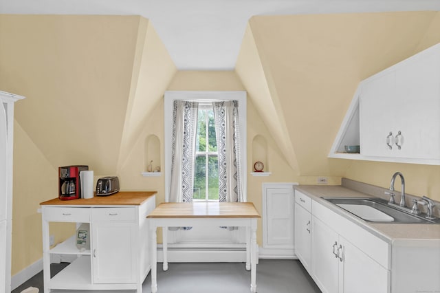 187 Whitehall Ave, Stonington, CT 06355 - kitchen with a sink, vaulted ceiling, baseboard heating, and white cabinetry