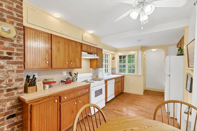 187 Whitehall Ave, Stonington, CT 06355 - kitchen with white appliances, light wood-type flooring, under cabinet range hood, a sink, and ceiling fan