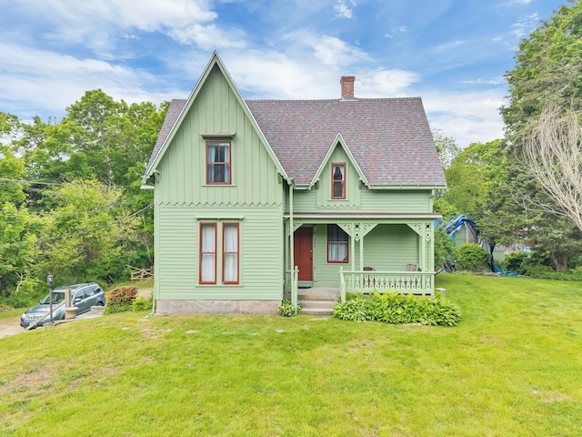 187 Whitehall Ave, Stonington, CT 06355 - victorian home with covered porch, board and batten siding, a chimney, a front yard, and a shingled roof