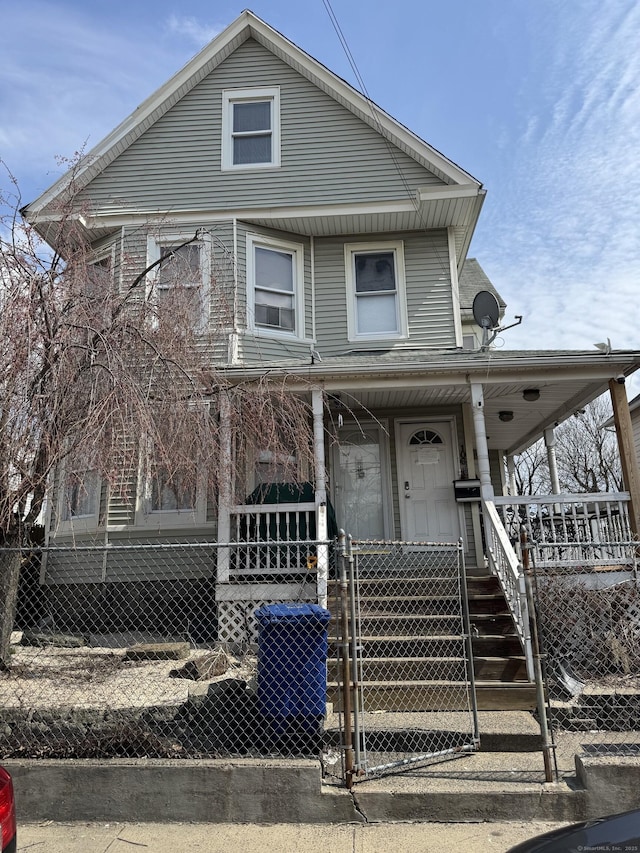 106 Jones Ave, Bridgeport, CT 06604 - view of front facade with a fenced front yard, covered porch, and a gate
