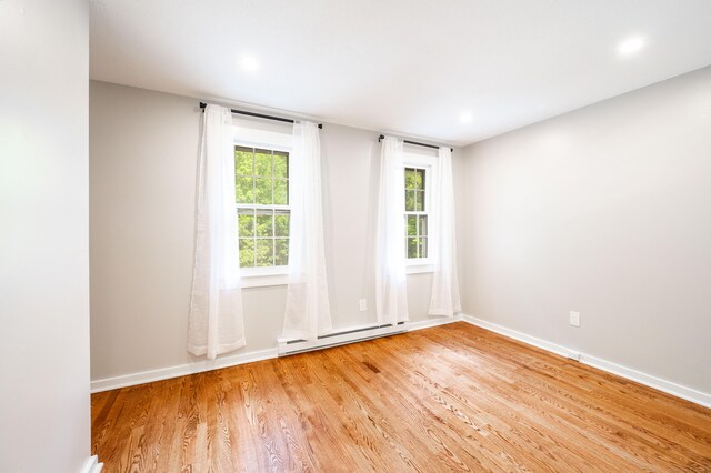 239 Old Farms Rd Apt 15B, Avon, CT 06001 - unfurnished room with baseboard heating, light wood-style flooring, baseboards, and recessed lighting