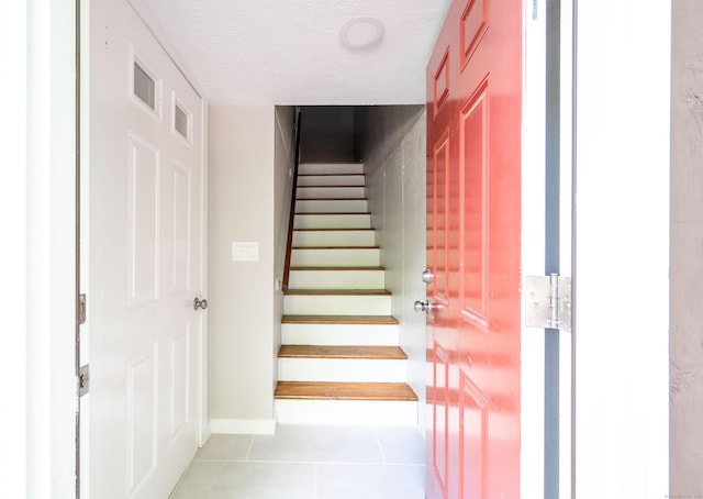 239 Old Farms Rd Apt 15B, Avon, CT 06001 - stairway with tile patterned flooring, a textured ceiling, and baseboards