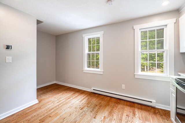 239 Old Farms Rd Apt 15B, Avon, CT 06001 - empty room with baseboard heating, baseboards, light wood finished floors, and a smoke detector