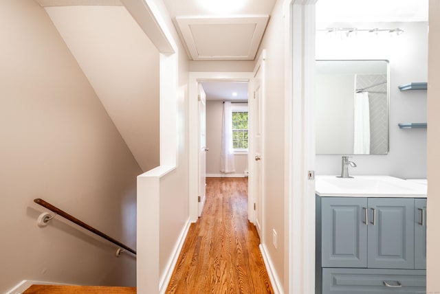 239 Old Farms Rd Apt 15B, Avon, CT 06001 - hall with an upstairs landing, a sink, and light wood-style flooring