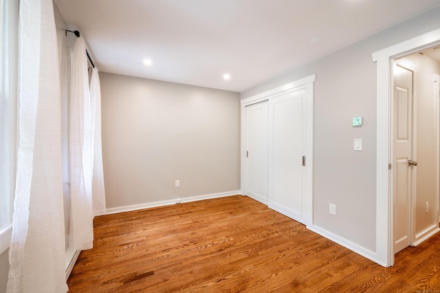 239 Old Farms Rd Apt 15B, Avon, CT 06001 - unfurnished bedroom featuring wood finished floors, recessed lighting, baseboards, and a closet