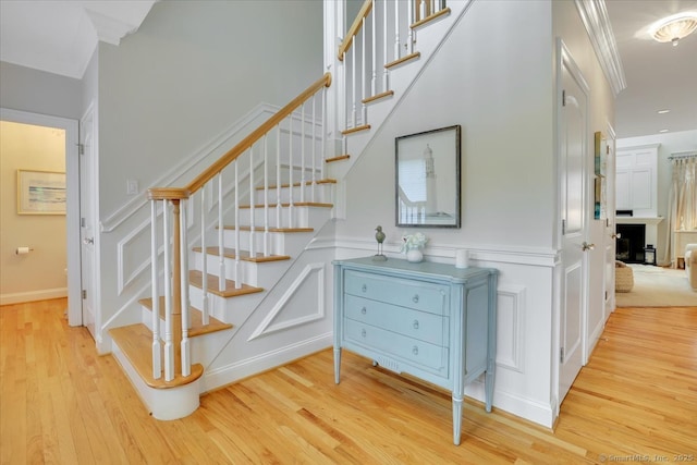 2 Lake Louise Dr, Westbrook, CT 06498 - stairs with a decorative wall, wood finished floors, and a wainscoted wall