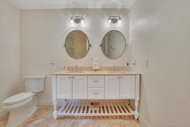 2 Lake Louise Dr, Westbrook, CT 06498 - bathroom featuring baseboards, double vanity, and toilet