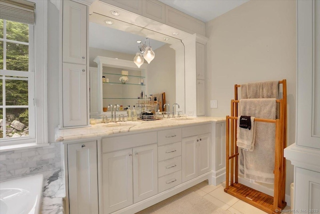 2 Lake Louise Dr, Westbrook, CT 06498 - bathroom with double vanity, a tub, tile patterned floors, and decorative backsplash
