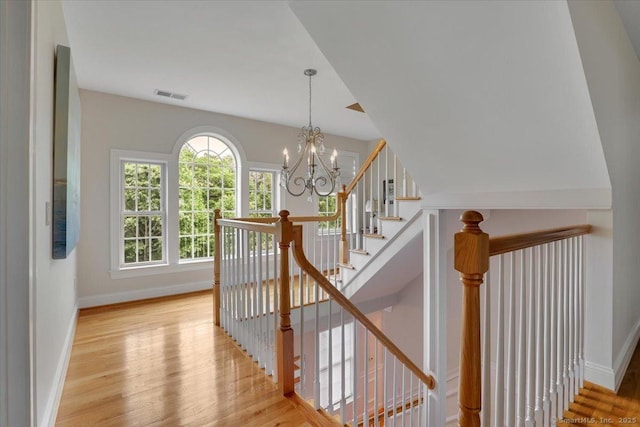 2 Lake Louise Dr, Westbrook, CT 06498 - staircase featuring wood finished floors, baseboards, and a chandelier