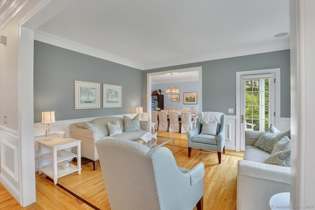 2 Lake Louise Dr, Westbrook, CT 06498 - living room featuring ornamental molding, wood finished floors, a wainscoted wall, and a chandelier
