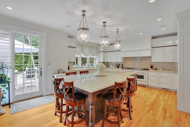 2 Lake Louise Dr, Westbrook, CT 06498 - dining area with healthy amount of natural light, light wood-style floors, a chandelier, and recessed lighting