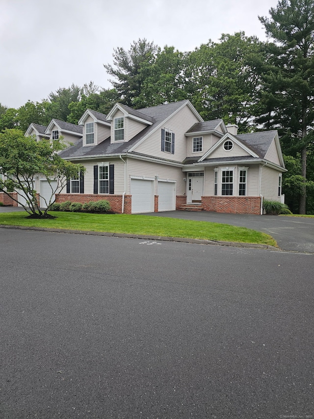 17 Marble Faun Ln Unit 17, Windsor, CT 06095 - view of front of house with brick siding, an attached garage, driveway, and a front yard