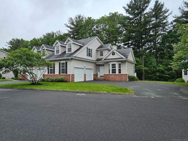 17 Marble Faun Ln Unit 17, Windsor, CT 06095 - view of front of property with driveway, brick siding, a front yard, and a garage