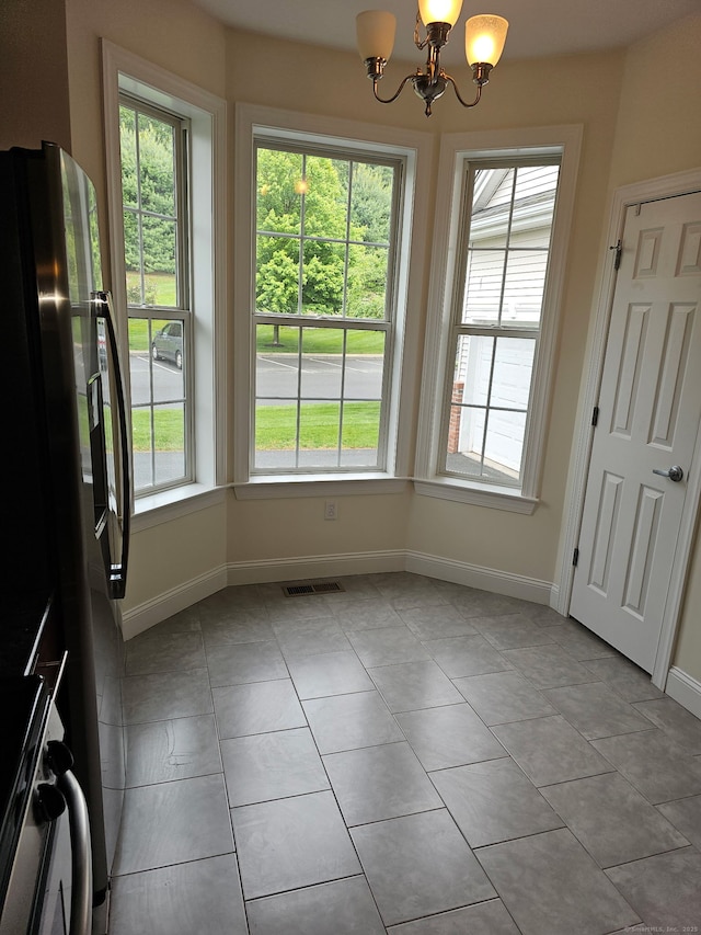 17 Marble Faun Ln Unit 17, Windsor, CT 06095 - unfurnished dining area with a chandelier, light tile patterned floors, and baseboards