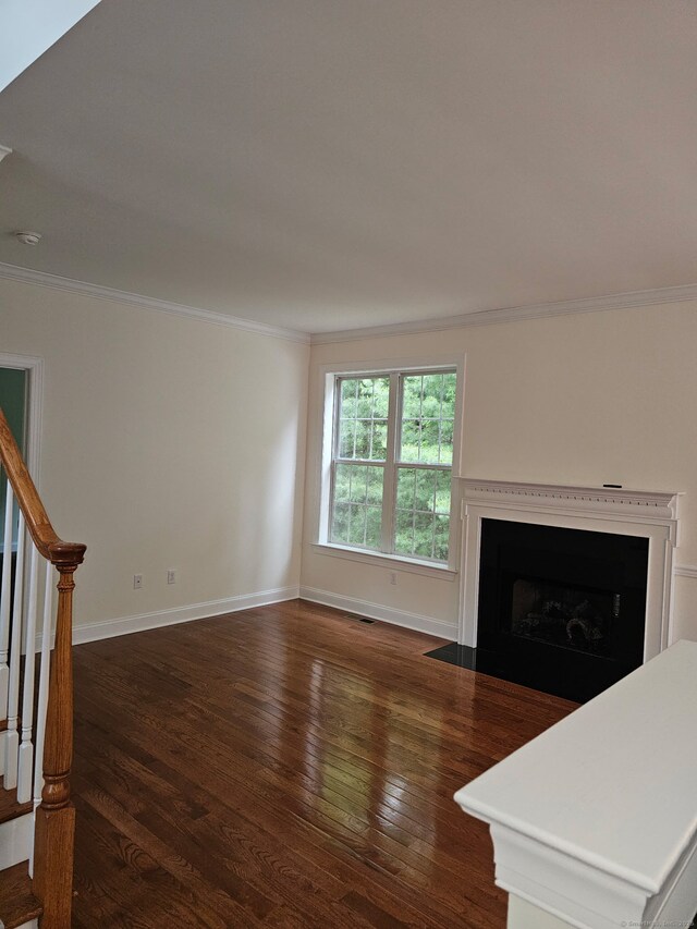 17 Marble Faun Ln Unit 17, Windsor, CT 06095 - unfurnished living room with ornamental molding, dark wood finished floors, stairway, baseboards, and a fireplace with flush hearth