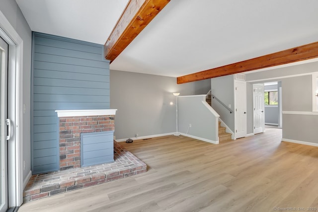 2 Edgehill Ct Unit 2, Woodbury, CT 06798 - unfurnished living room with beam ceiling, a fireplace, stairway, wood finished floors, and baseboards