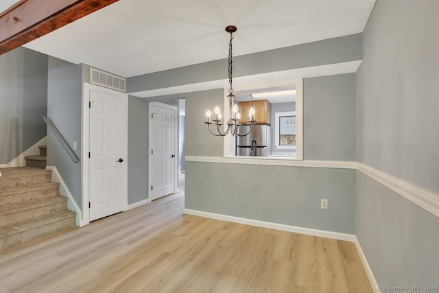 2 Edgehill Ct Unit 2, Woodbury, CT 06798 - unfurnished dining area featuring a chandelier, light wood-type flooring, stairs, and baseboards
