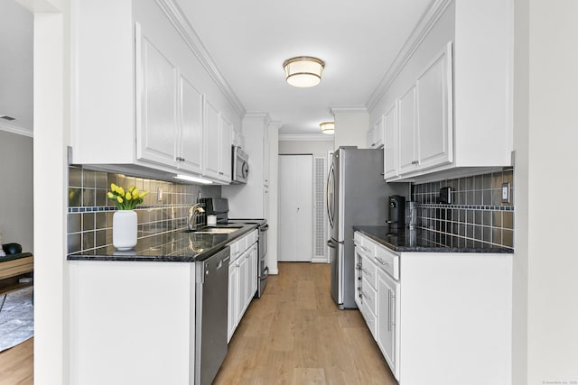 116 Southport Woods Dr, Fairfield, CT 06890 - kitchen with appliances with stainless steel finishes, white cabinetry, crown molding, light wood-style flooring, and a sink