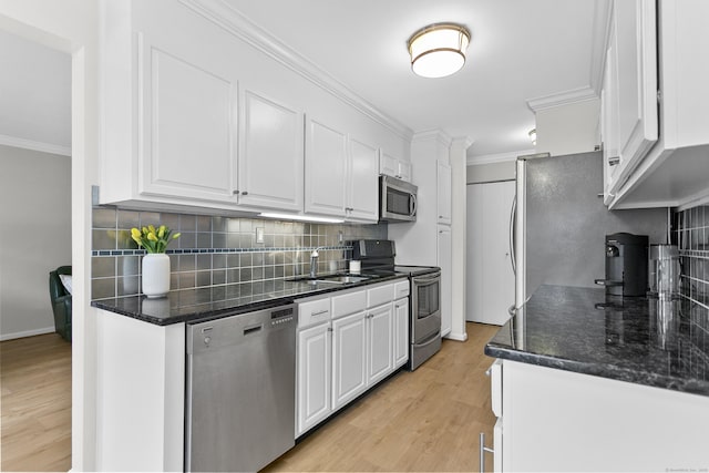 116 Southport Woods Dr, Fairfield, CT 06890 - kitchen with stainless steel appliances, a sink, white cabinetry, crown molding, and decorative backsplash