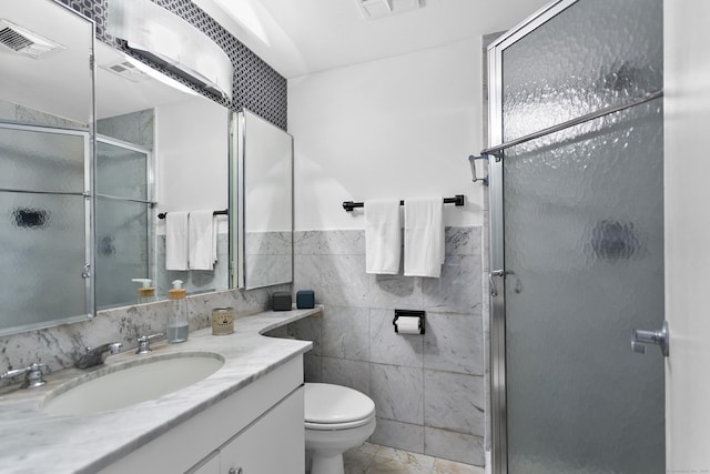 116 Southport Woods Dr, Fairfield, CT 06890 - bathroom featuring tile walls, vanity, toilet, a shower stall, and tile patterned floors